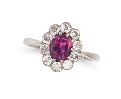 AN UNHEATED RUBY AND DIAMOND CLUSTER RING in 18ct white gold, set with an oval cut ruby of approximately 1.42 carats in a clu