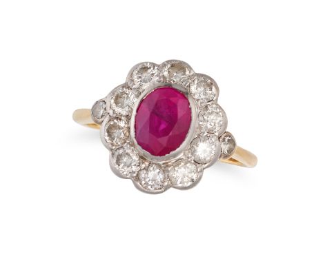 A RUBY AND DIAMOND CLUSTER RING in 18ct yellow gold, set with an oval cut ruby in a cluster of round brilliant cut diamonds, 