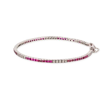 AN ART DECO RUBY AND DIAMOND LINE BRACELET in platinum, set with groups of square step cut rubies and old cut diamonds, one r
