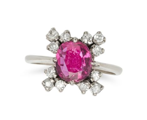 A RUBY AND DIAMOND CLUSTER RING in 18ct white gold, set with a cushion cut ruby of approximately 1.25 carats in a cluster of 