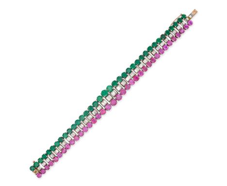 A RUBY, DIAMOND AND EMERALD BRACELET in yellow and white gold, set with a row of baguette cut diamonds between rows of round 