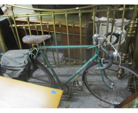 A vintage Hopper Tour Anglais modele de Luxe bicycle in a green metallic colour with a Brookes leather saddle seat and canvas