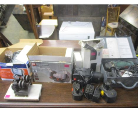 A quantity of tools to include a Bosch angle grinder, an electric drill sharpener, a Draper 500w free standing halogen lamp, 