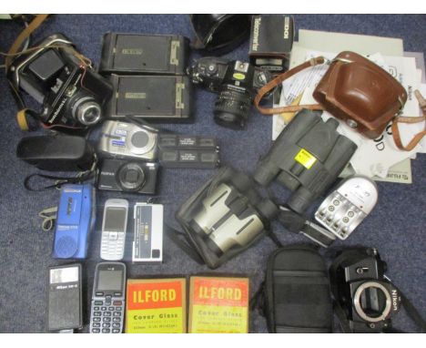 Cameras and photographic equipment to include vintage Kodaks, a Nikon EM modern digital cameras, accessories and manuals, bin