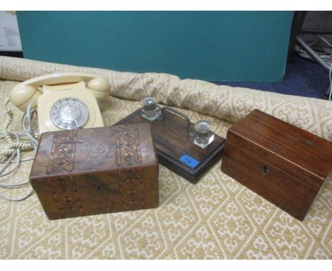 A roll of beige fabric with diamond pattern, a vintage cream coloured BT telephone, a mid 20th century oak desk set with glas