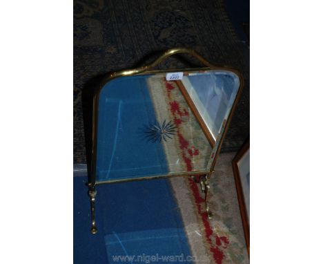 A Brass mirrored fire screen.