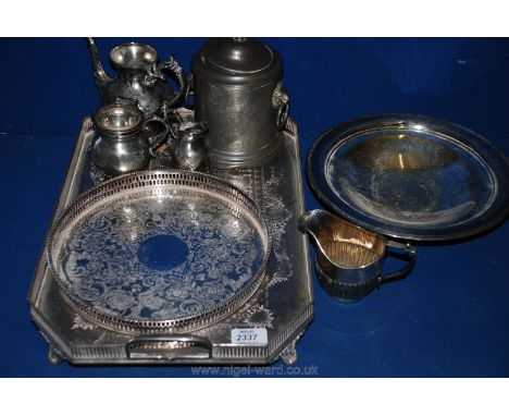 A pewter lidded tea Caddy with lion's head ring handles, a plated teapot, sugar bowl and milk jug, etc. standing on a two han