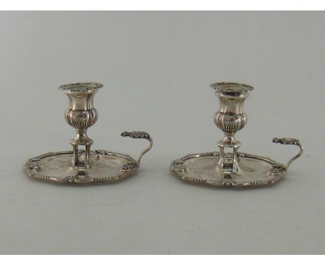 A pair of George III silver chambersticks by Nathaniel Smith & Co., Sheffield, 1809, with shell, leaf, gadroon and anthemion 