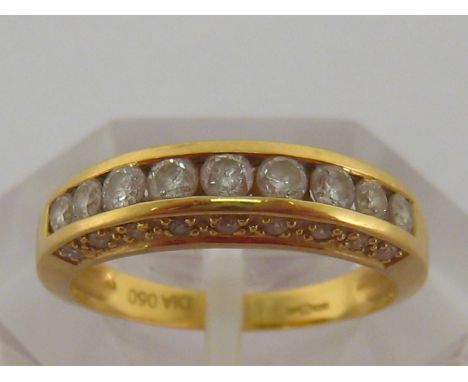 An 18 carat yellow gold and diamond half hoop ring, the central row of brilliants totalling approximately 0.5 carat, the gall