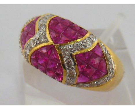 A ruby and diamond bombe ring, set with panels of calibre cut rubies between brilliant cut borders, the yellow gold shank sta