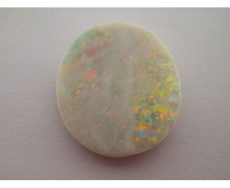 A loose opal stone, polished on one side, the oval stone 21 x 19mm, polished to one side, 2 gms. VAT will be added to the ham