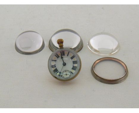 A brass mounted glass ball watch with white enamel dial and visible movement,  together with three hemisphere glasses and one