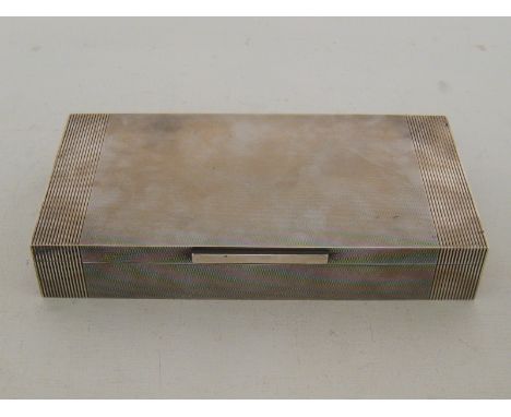 A good engine-turned silver cigarette box by Padgett & Braham Ltd., London, 1946, with ribbed vertical band at either side, c