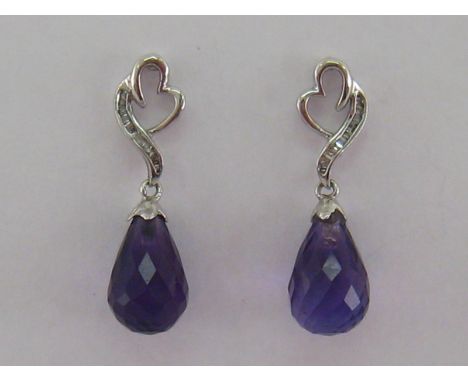 A pair of 18 carat white gold, diamond and amethyst earrings, the briolette drops each 11.6mm long, open work surmounts set w