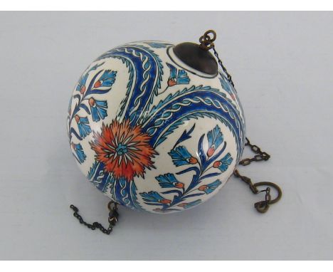 A Turkish ceramic mosque ball, probably Kutahya (Western Armenia), 19th century, brass mounts and chains dependent, painted w
