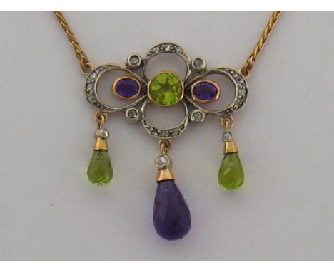 An Edwardian 'Suffragette' style peridot, amethyst and diamond pendant, the quatrefoil gold backed bow mount set overall with