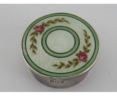 A small silver box, the pull off lid with enamel roses on an engine turned white ground within green bands. Levi and Salaman,