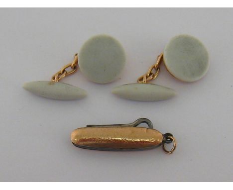 A pair of 15 carat gold mounted enamel cuff links, the textured circular discs 14mm diameter, with torpedo connections, toget