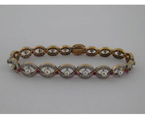 A fine early 20th century pearl, ruby and diamond bracelet by Koch, circa 1915, the central row of untested pearls 4.1-3mm wi