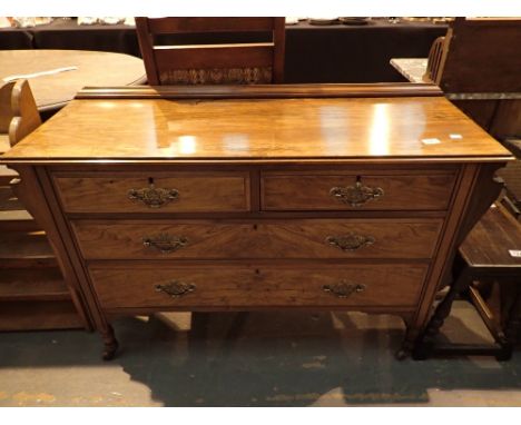 Walnut chest of two short over two long drawers on turned supports with ceramic castors