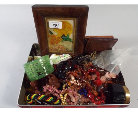 A Tin Containing Costume Jewellery, Prints Etc. 