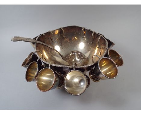 A Silver Plated Punch Bowl, Silver Plated Ladle and Twelve Silver Plated Cups.