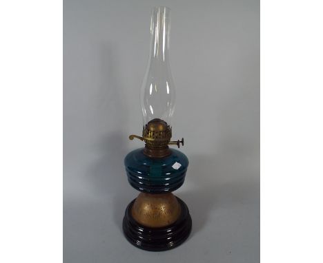A Late Victorian Oil Lamp with Blue Glass Reservoir.