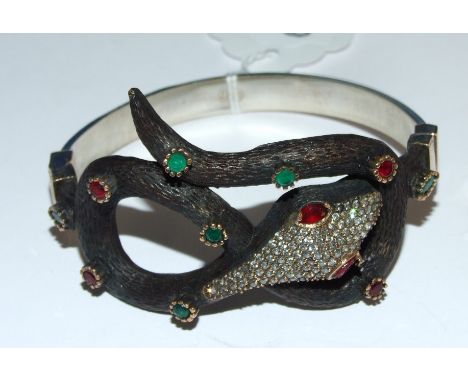 A silver and gem set snake bangle