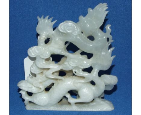 A Chinese carved jade group, of dragons chasing a flaming pearl (minor chips), 11 cm high