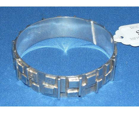 A silver bangle, of geometric design, Graham Watling, London 1975, boxed Condition report Report by RB

Generally good condit