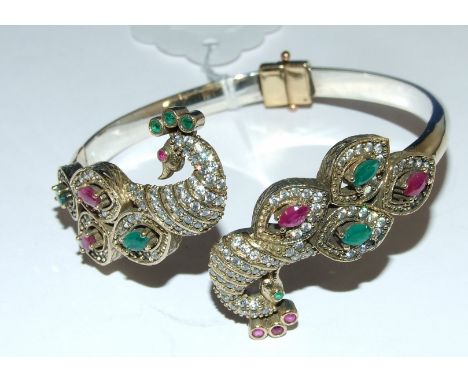 A silver and ruby set peacock bangle