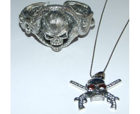 A silver skull bangle and necklace (not bracelet)