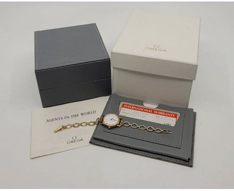 An Omega De Ville 18ct. gold ladies' quartz wrist watch, c.1995, cal.1470, having signed white enamel circular Roman numeral 