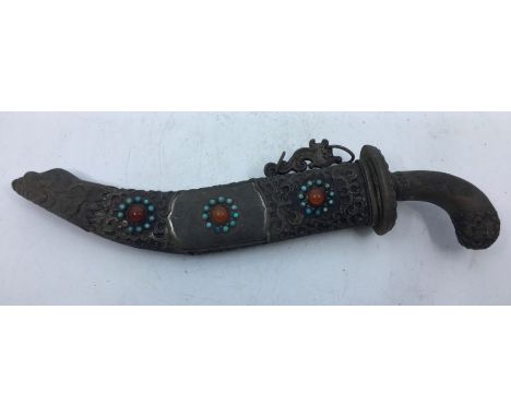 A 20th century Sino-Tibetan white metal mounted dagger, the scabbard set cabochon turquoise and red glass, length of curved b