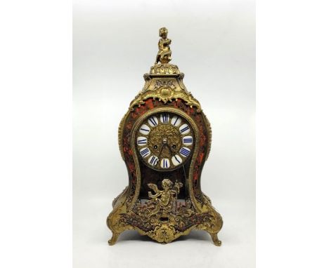 A late 19th century French ormolu mounted boulle mantel clock, gong strike, having twelve piece blue on white enamel cartouch
