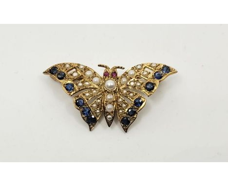 A 9ct. gold, sapphire, cultured pearl and ruby set butterfly brooch, having body and wings set graduated cultured pearls with