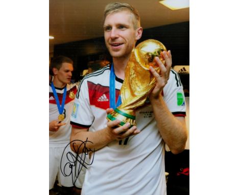 Per Mertesacker signed 12x8 inch colour photo pictured celebrating with the World cup while playing for Germany. Good conditi