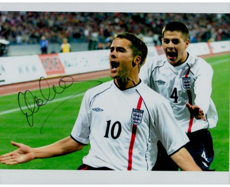 Michael Owen signed 10x8 inch colour photo pictured while celebrating playing for England. Good condition. All autographs com