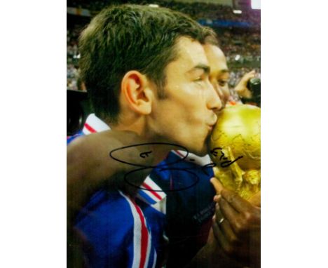 Zinedine Zadane signed 12x8 inch colour photo pictured celebrating with the world cup while playing for France. Good conditio