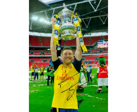 Football Laurent Koscielny signed 12x8 inch colour photo pictured with the FA CUP while playing for Arsenal. Good condition. 