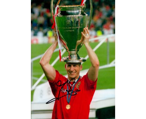 Jaap Stam signed 12x8 inch colour photo pictured with the Champions league trophy while playing for Manchester United. Good c