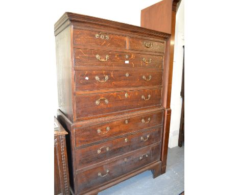 19th Century oak chest on chest, the moulded cornice above two short and six long drawers with brass swan neck handles raised