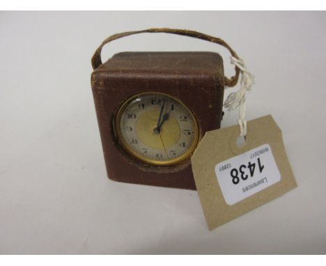 Small 1930's gilt brass cased travel alarm clock by Zenith in a fabric covered travel case