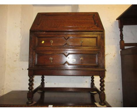 Early 20th Century oak bureau with a moulded fall front above two drawers on bobbin turned supports with stretchers