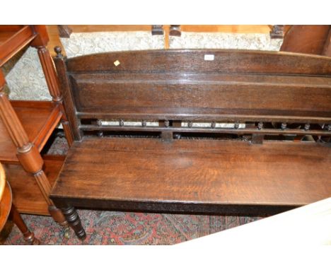 Victorian oak hall bench, the moulded panel and spindle back above a plank seat and turned tapering front supports