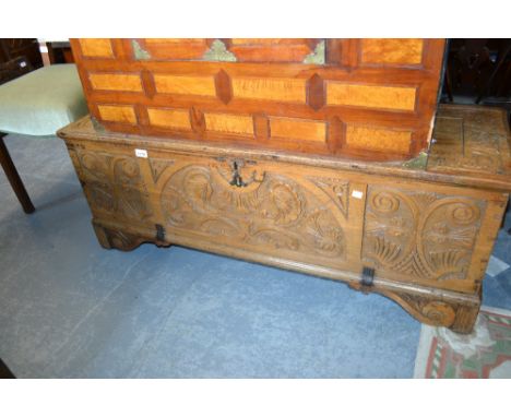 17th Century light oak plank coffer, the hinged lid and front decorated with relief carving (probably of later date), the bas