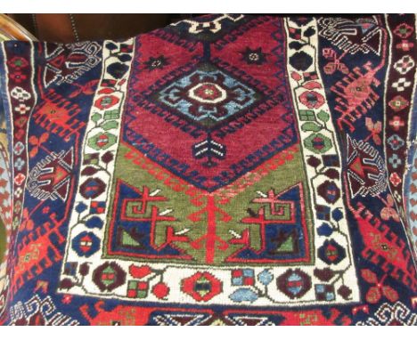 Belouch rug with triple hooked medallion design in shades of wine red, blue and green, 5ft x 3ft 6ins approximately