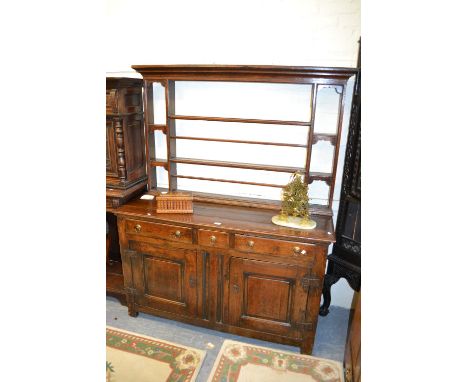 Mid 18th Century oak dresser, the open shelf back above three drawers and two fielded panelled doors with iron hinges and bra