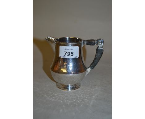 Arts and Crafts beaten Sterling silver cream jug with ebony handle