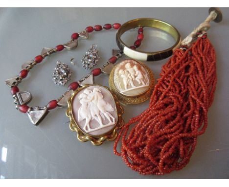Two gilt metal mounted cameo brooches, a white metal and bead necklace, coral necklace and a bangle